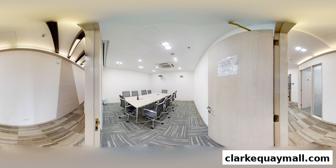 A modern conference room with a large table, chairs, and a projector.
