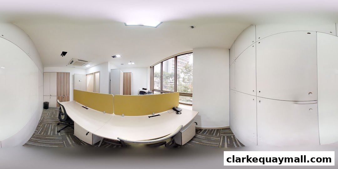 A modern office interior with desks, chairs, and large windows overlooking a city.