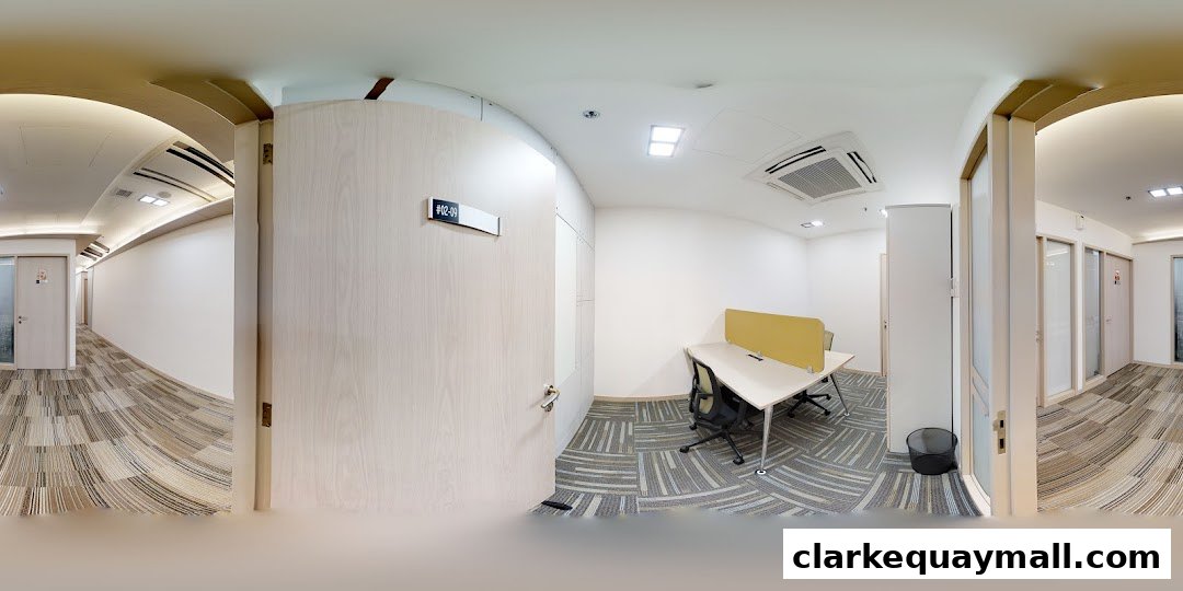 Interior view of a modern office space with desks, chairs, and a hallway.