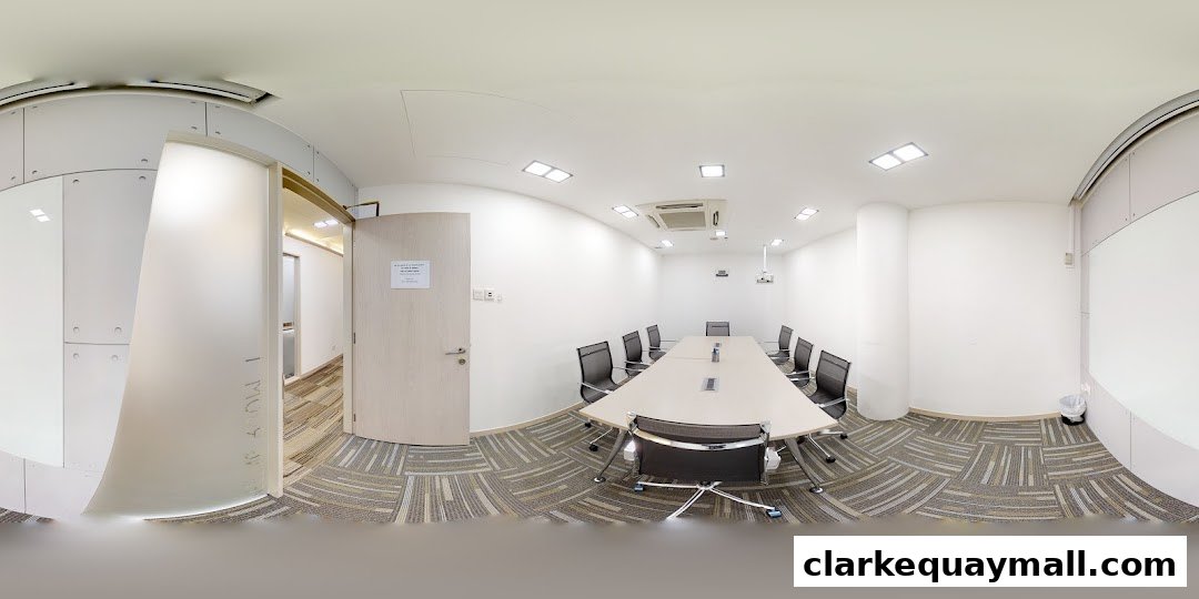 A modern conference room with a long table, chairs, and a whiteboard.