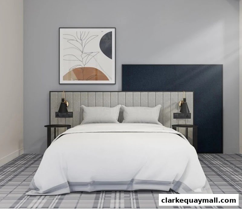 A modern hotel room with a king-size bed, bedside tables, and abstract art.