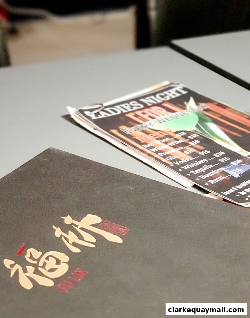 A menu from Fu Lin restaurant featuring drinks and a Ladies Night promotion.