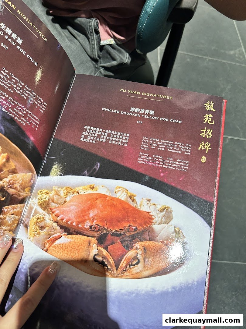 A menu page showcasing a signature dish of chilled drunken yellow roe crab.