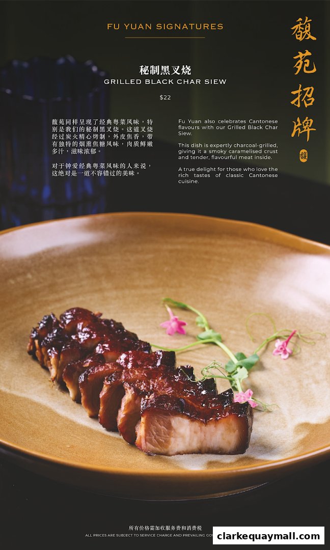 A close-up of a plate of grilled black char siew with garnishes.