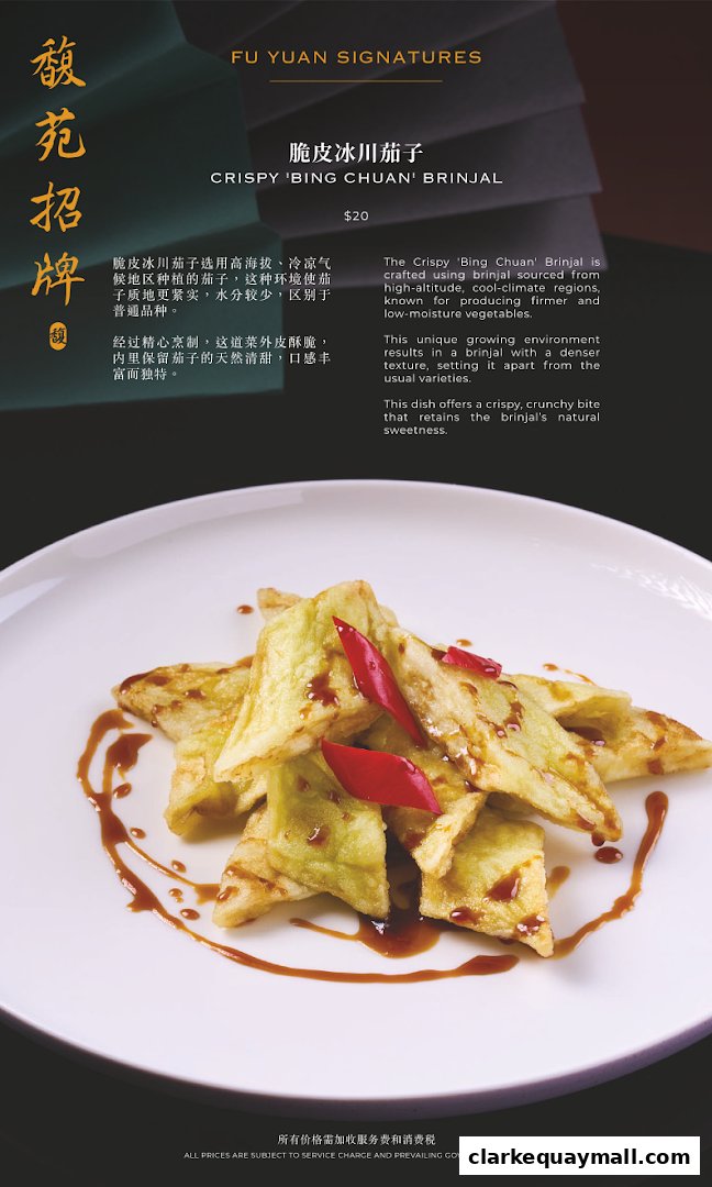 A close-up of crispy fried eggplant drizzled with sauce and garnished with chili peppers.