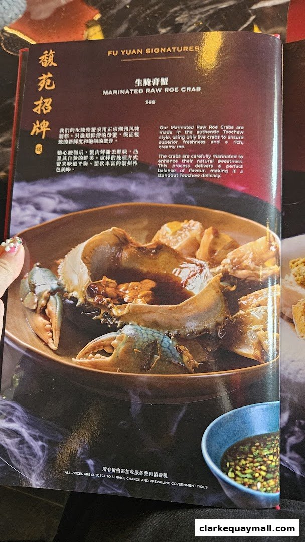 A menu page featuring a close-up of marinated raw roe crab with accompanying text.