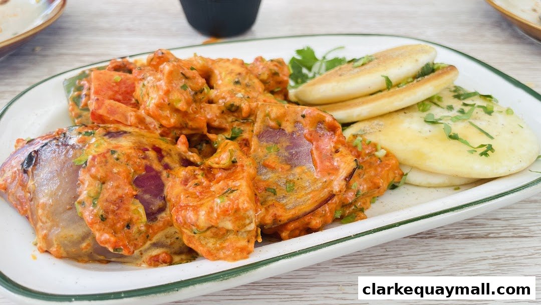 A close-up of a delicious Indian dish with naan bread and a creamy sauce.
