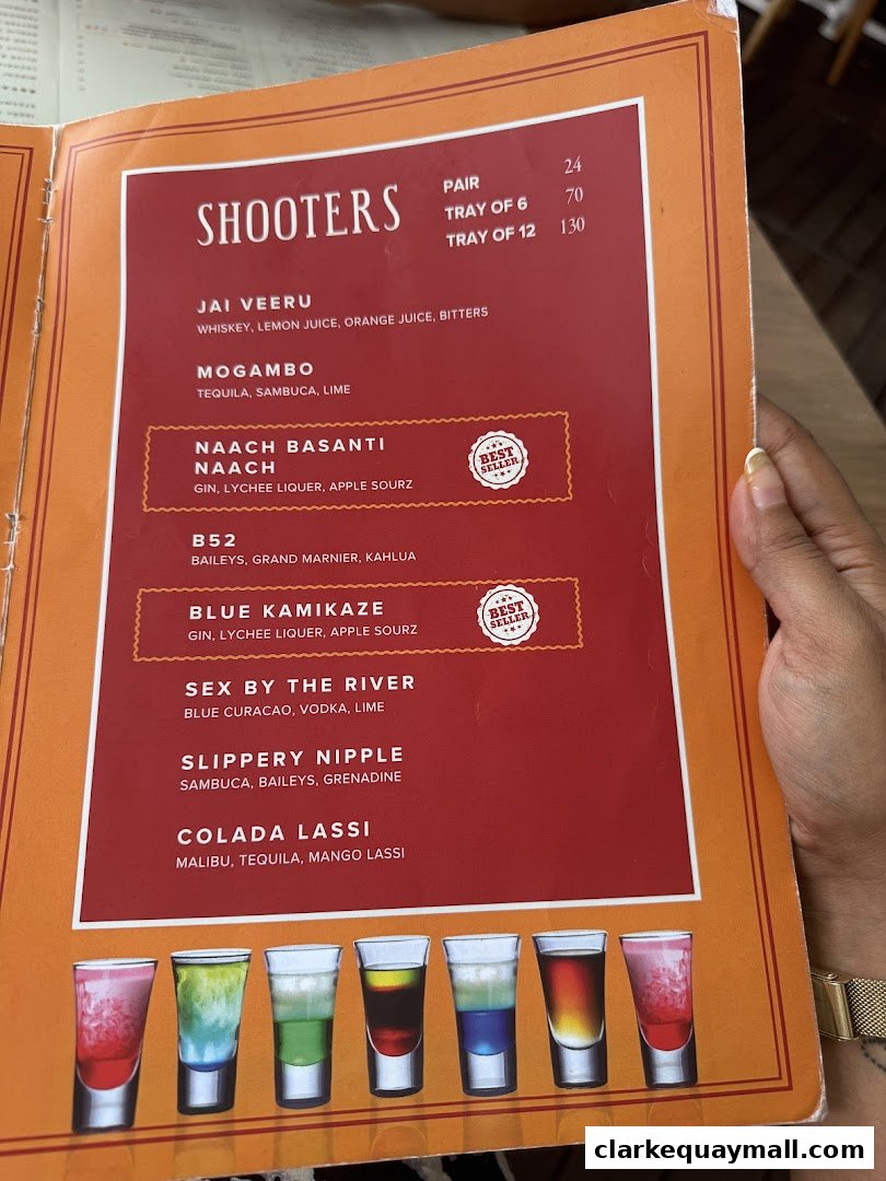 A menu page from Gabbar Bistro Bar featuring a selection of colorful shooters with their ingredients.