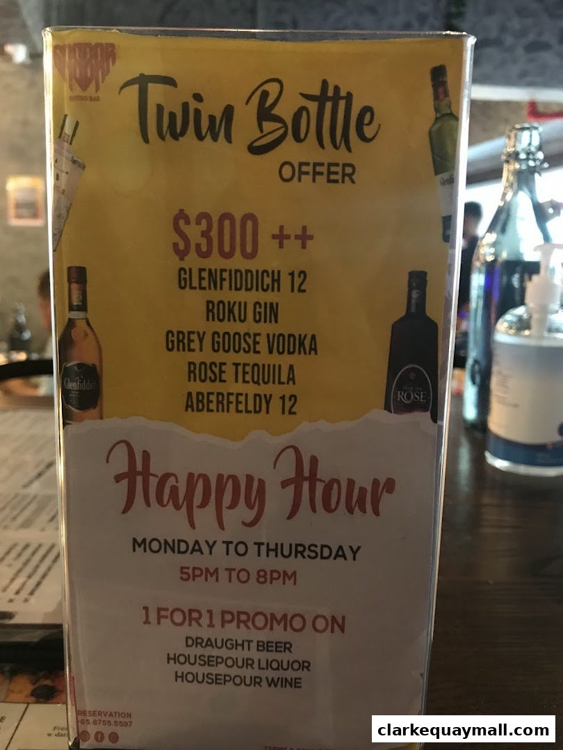 A menu board advertising a twin bottle offer and happy hour specials at Gabbar Bistro Bar.