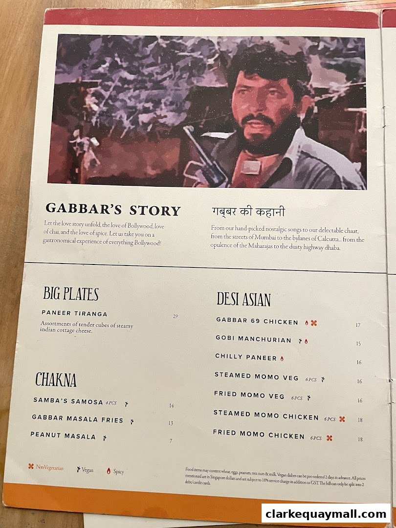 A menu page featuring Bollywood-themed dishes and a picture of a man with a gun.