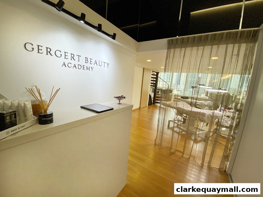 Interior of Gergert Beauty Academy with a reception desk and treatment beds visible.