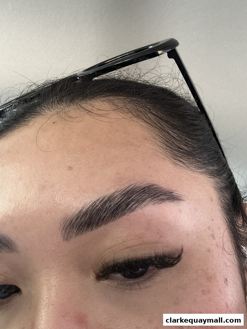 Close-up of a woman's eye with perfectly shaped eyebrows and long eyelashes.