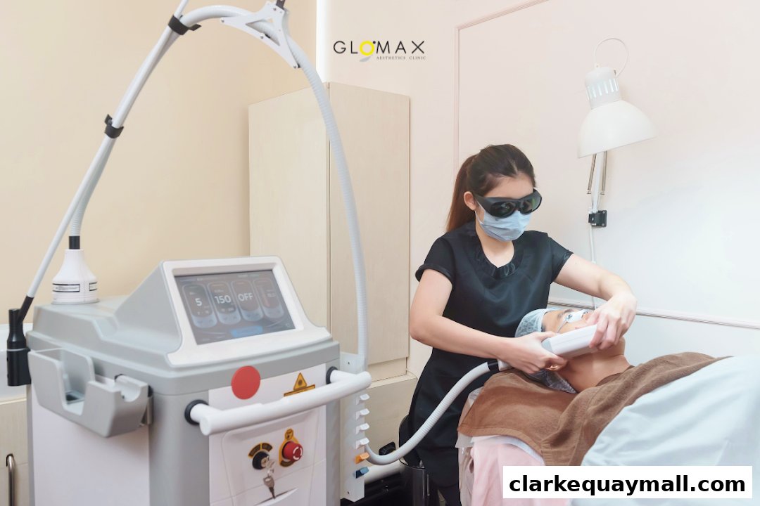 Aesthetician performing a facial treatment with a laser device on a client.
