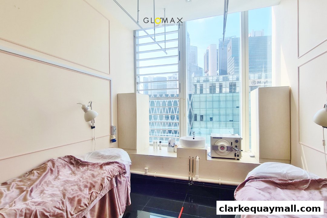 Interior of an aesthetics clinic with two treatment beds and a city view.