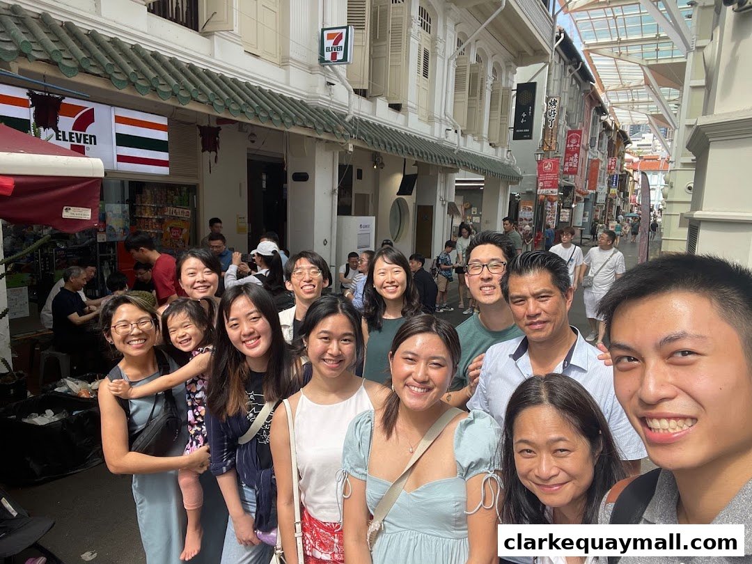 A group of people smiling for a selfie in front of a 7-Eleven store.