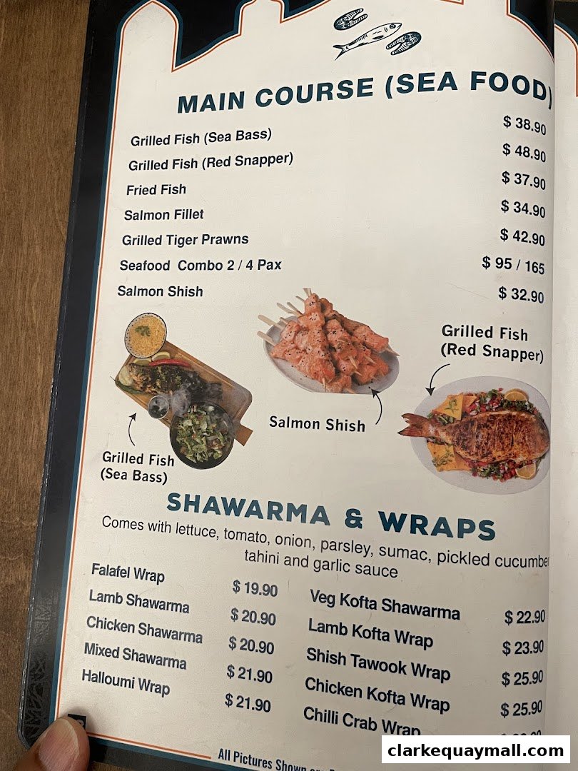 A menu featuring main course seafood dishes and shawarma wraps with prices.