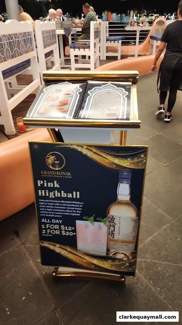 A promotional sign for Grand Konak's Pink Highball cocktail featuring Hatozaki whisky.