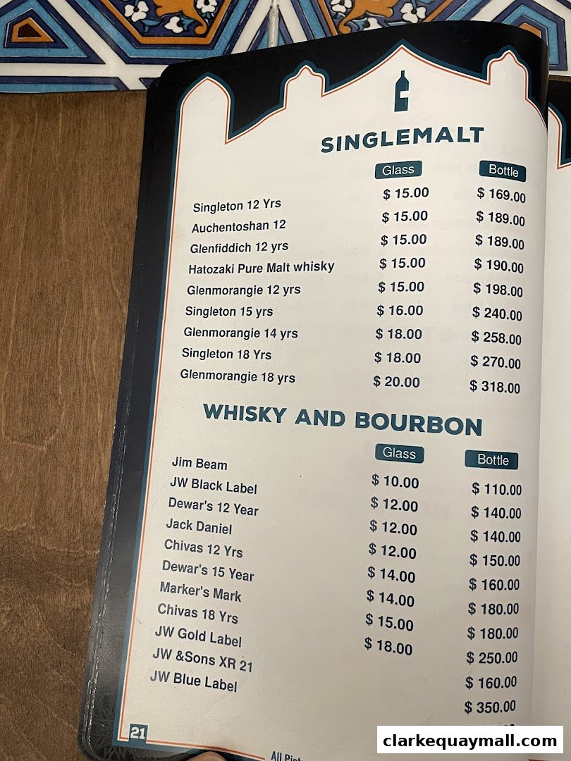 A menu featuring Single Malt Scotch and Bourbon whiskies with prices for glass and bottle servings.