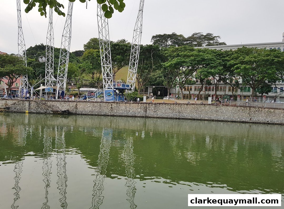 The GX-5 Extreme Swing attraction with its tall towers and a river in the foreground.