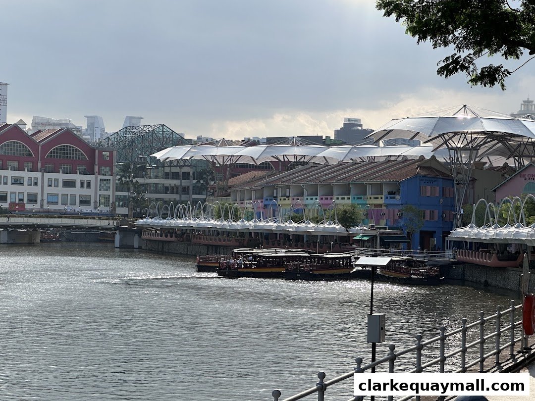 A scenic view of a riverfront with colorful buildings and boats under a cloudy sky.