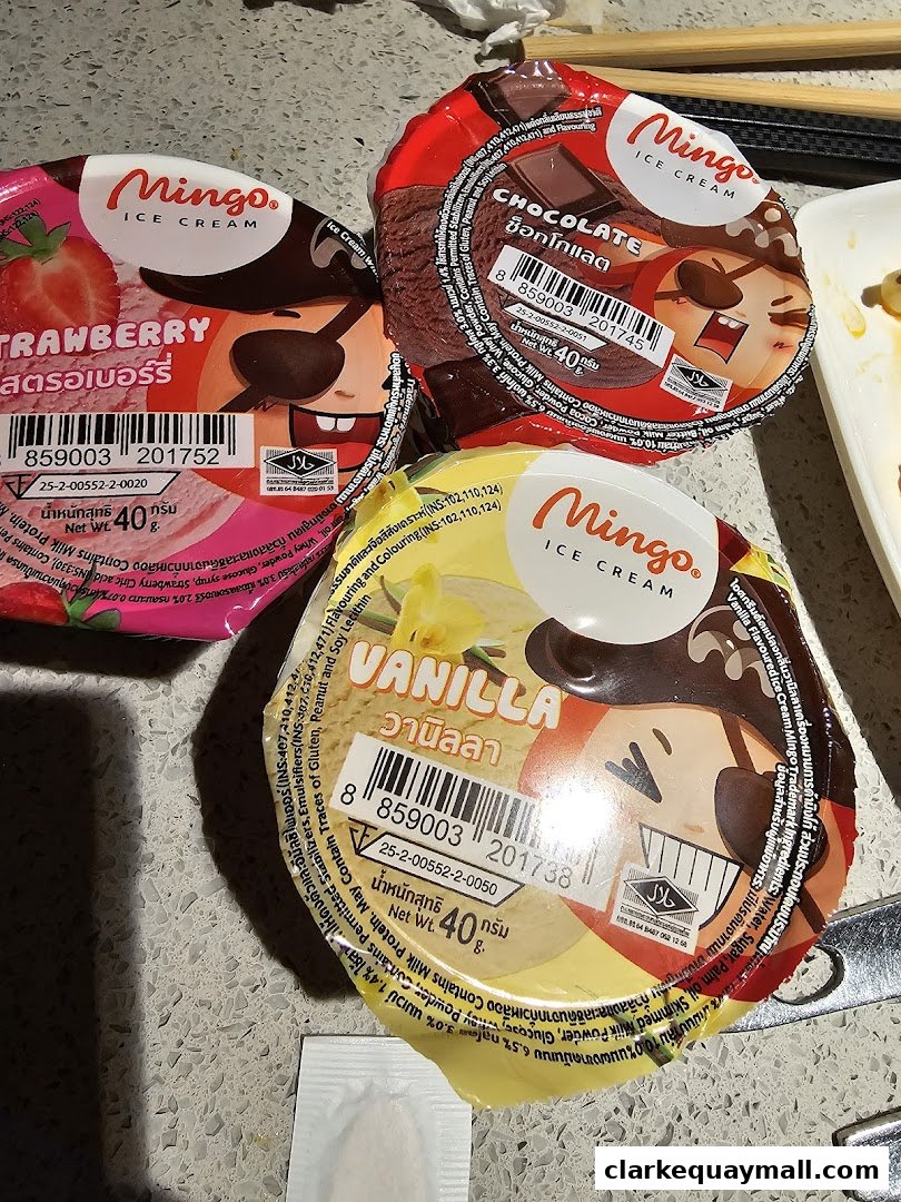 Three cups of Mingo ice cream in strawberry, chocolate, and vanilla flavors.