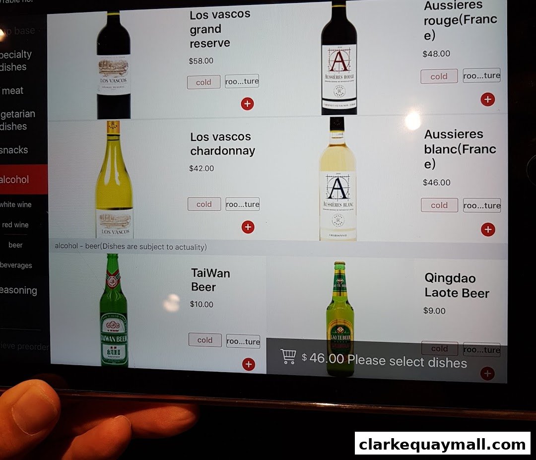 A digital menu displaying various alcoholic beverages including wines and beers with prices.