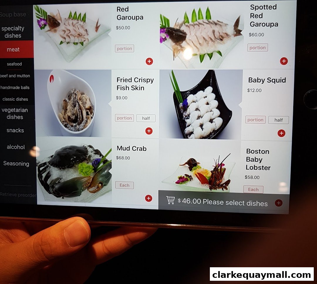 A tablet screen displaying a menu of seafood and meat dishes for hot pot.