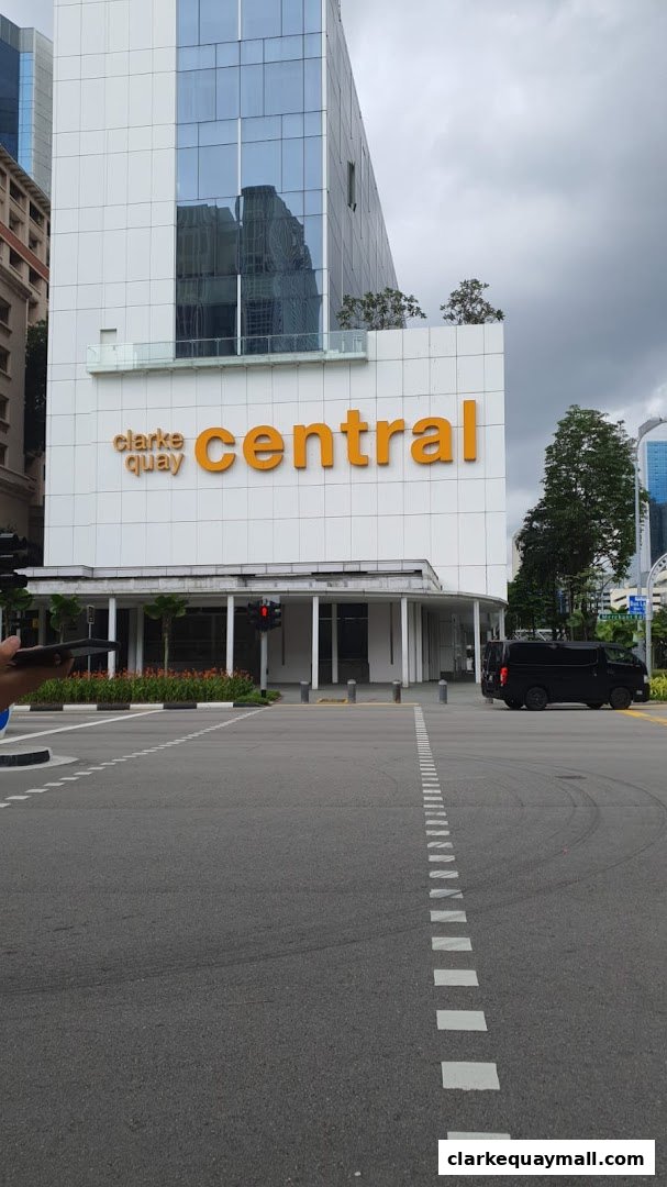 Exterior view of the Clarke Quay Central building with large orange signage.