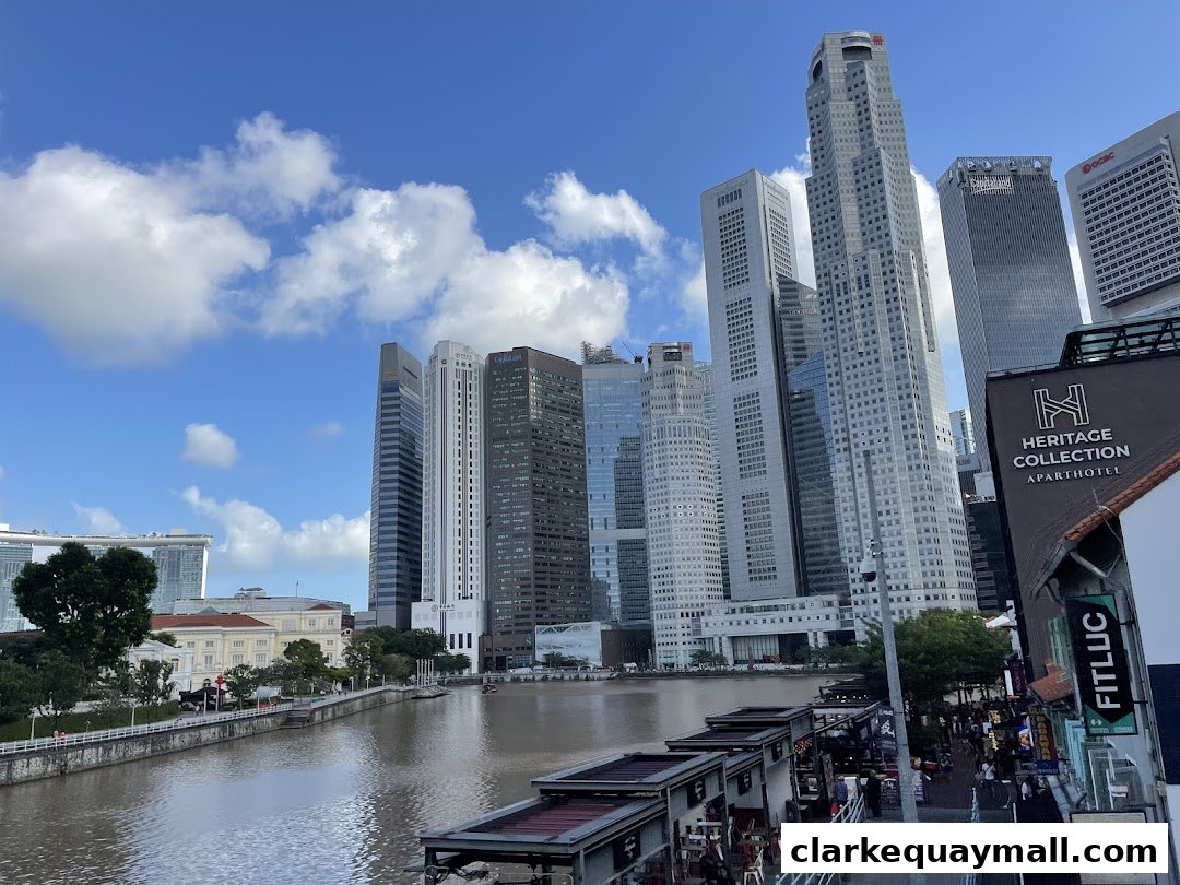 A cityscape view of Singapore's financial district with a river in the foreground.