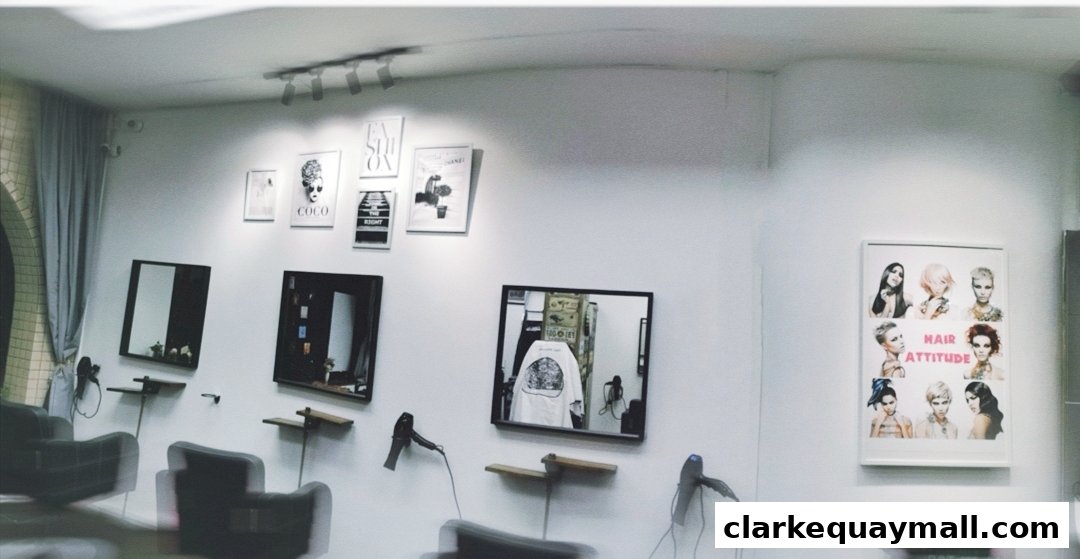 Interior of a modern hair salon with styling chairs, mirrors, and hair art on the walls.