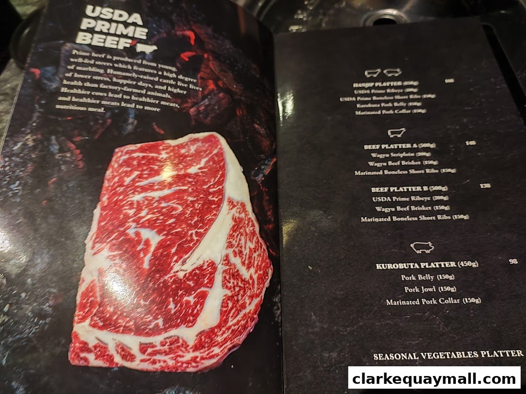 A menu page showcasing USDA Prime Beef and Kurobuta Pork platters with detailed descriptions and prices.