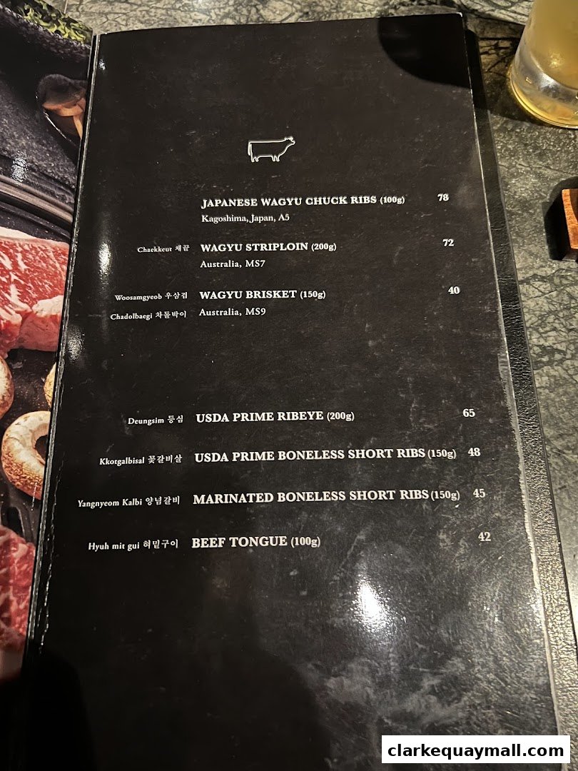 A menu from Hanjip Korean Grill House featuring various cuts of Wagyu and USDA Prime beef.