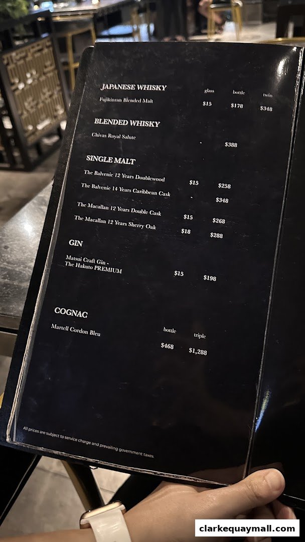 A menu featuring Japanese whisky, blended whisky, single malt, gin, and cognac with prices.
