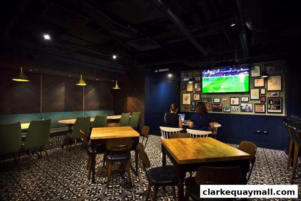 Interior of a stylish bar with people watching a soccer match on a large screen.