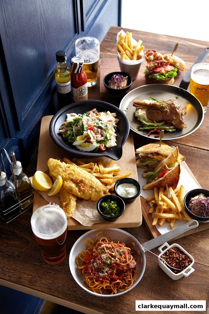 A spread of delicious pub-style food including fish and chips, pasta, and a burger.