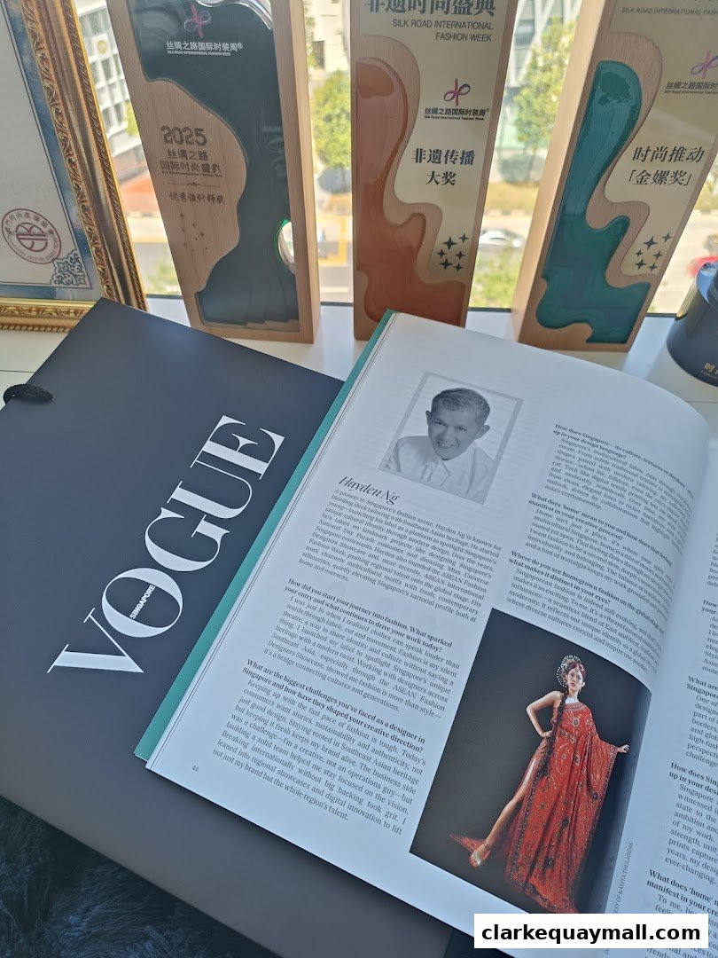 A magazine spread featuring fashion designer Hayden Ng, alongside awards and a Vogue Singapore magazine.