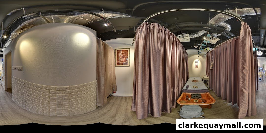Interior view of a wellness spa with massage beds and treatment areas.