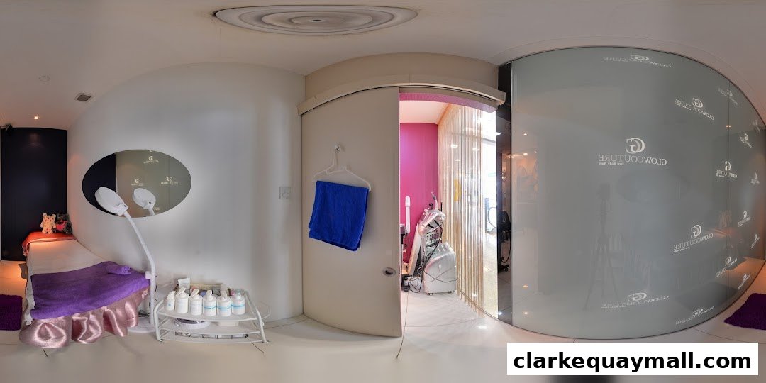 Interior view of a modern wellness and beauty treatment room with a massage bed and equipment.