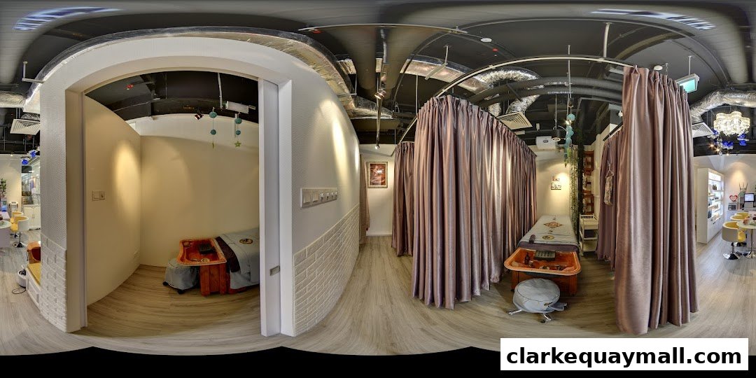 Interior view of a wellness spa with treatment beds and curtains.