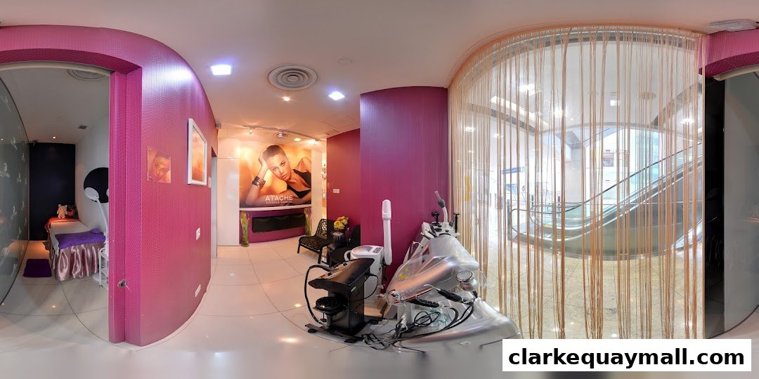 Interior view of a beauty salon with treatment beds, equipment, and a view of escalators.