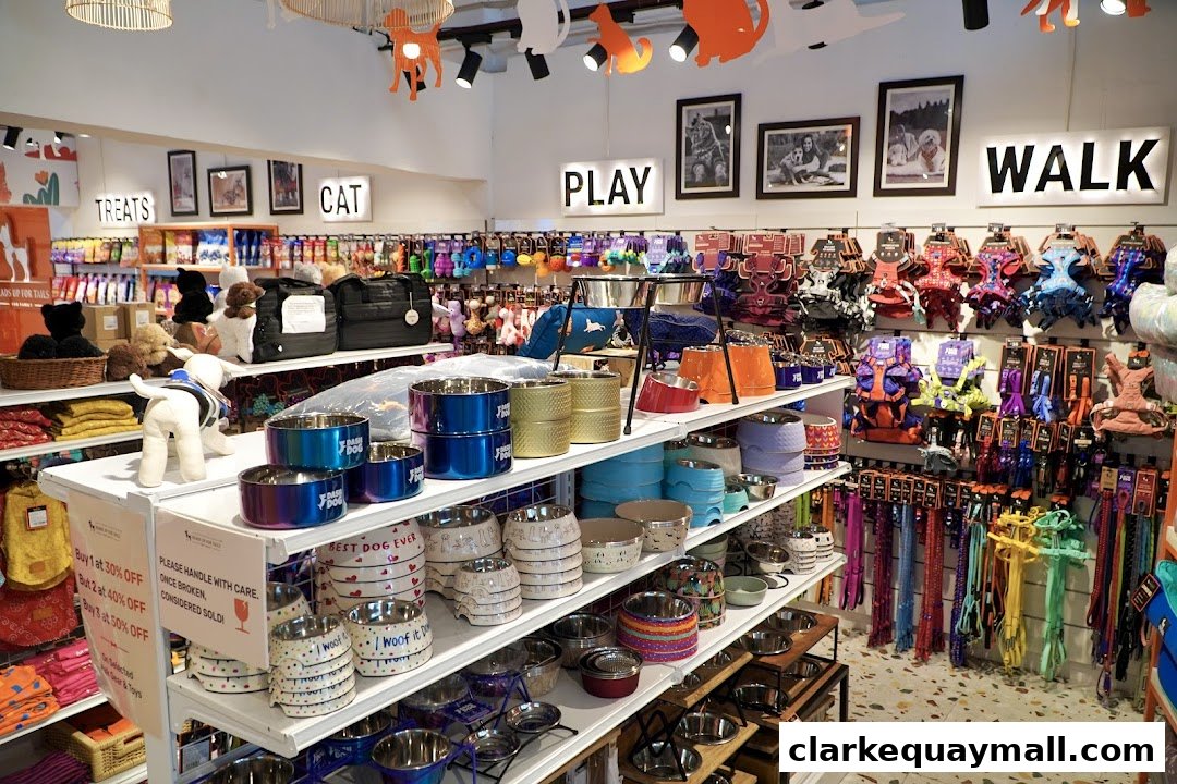 Interior of a pet store with shelves stocked with dog bowls, leashes, harnesses, and toys.