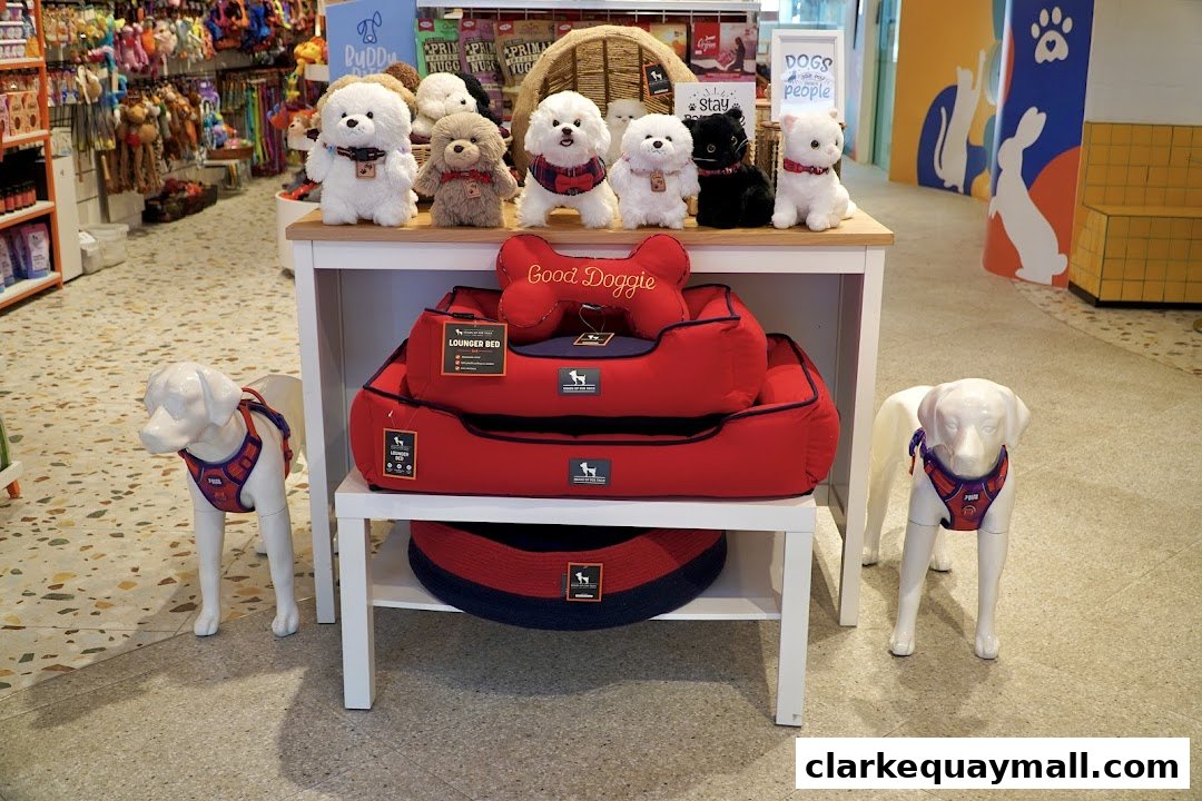 A display of dog beds and plush toys in a pet store, with dog mannequins.