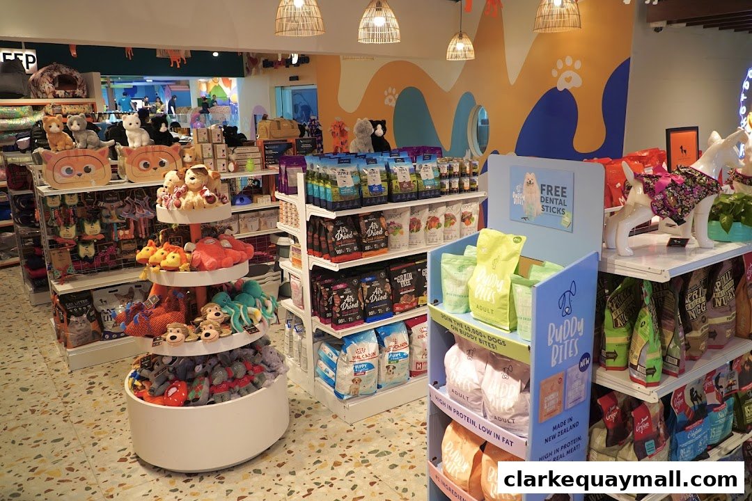 Interior of a pet store with shelves stocked with dog food, toys, and accessories.