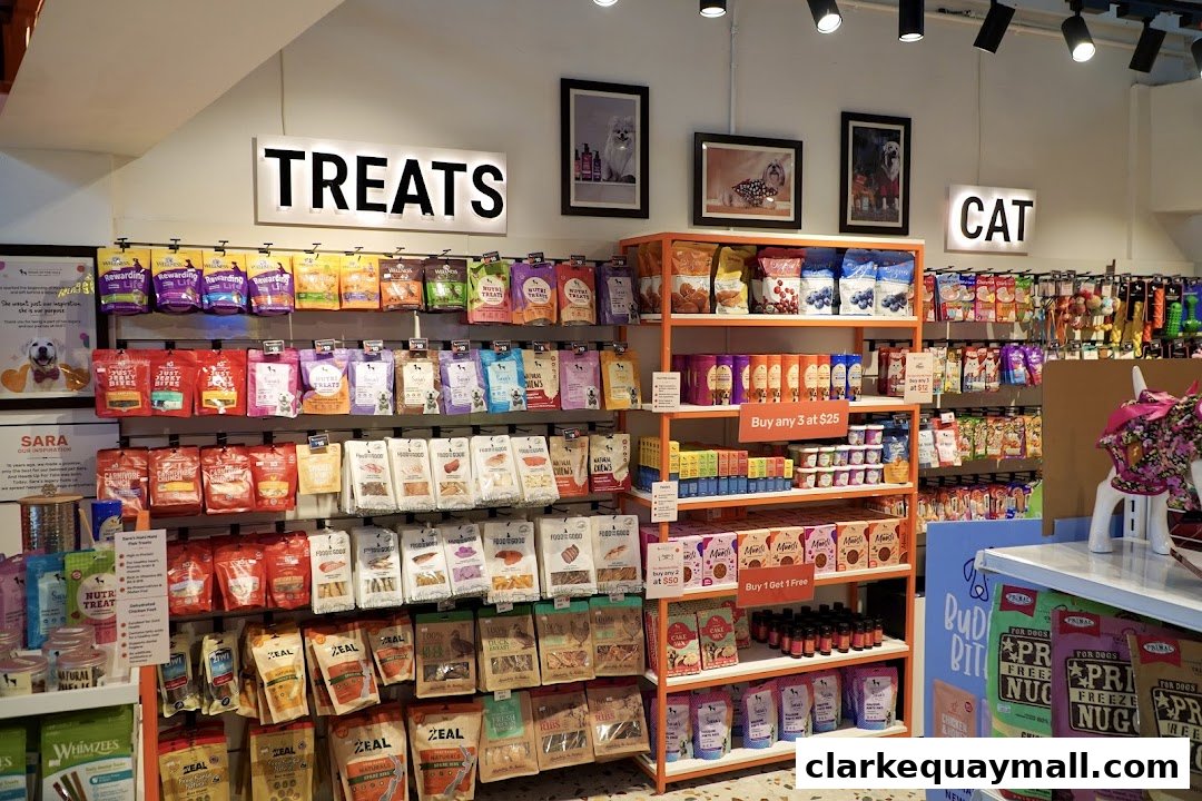 A well-stocked pet store interior with shelves full of dog and cat treats and accessories.