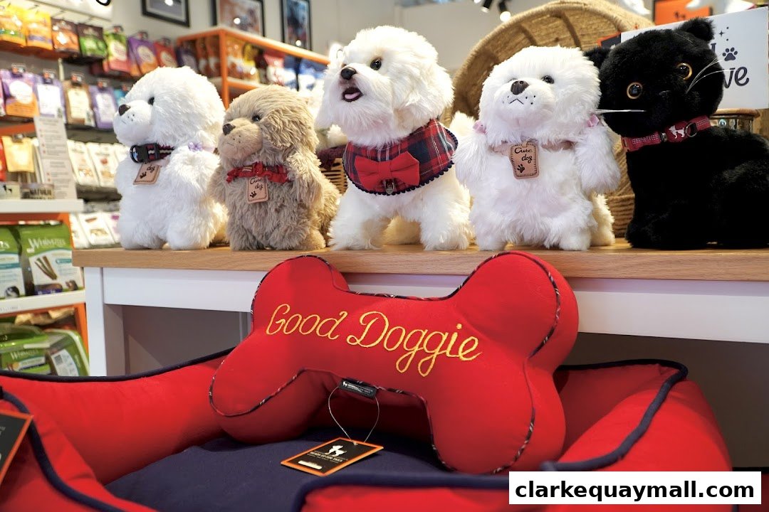 Plush dog and cat toys displayed on a shelf above a red dog bed.