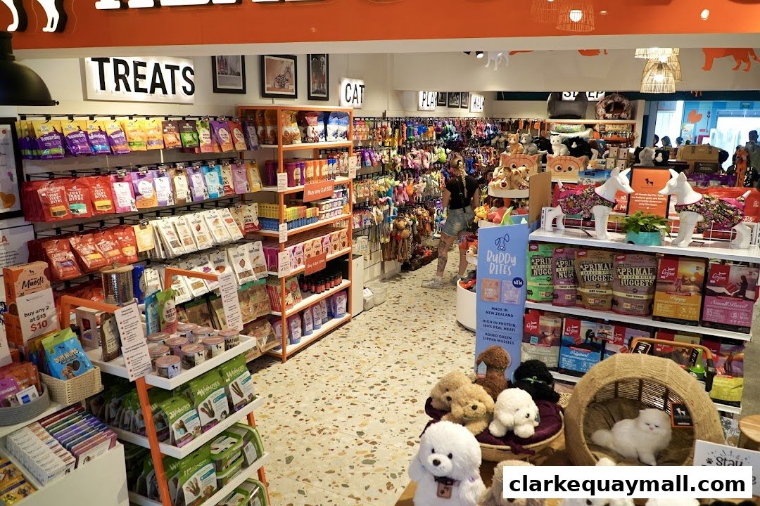 Interior of a pet store with shelves stocked with pet food, treats, and toys.