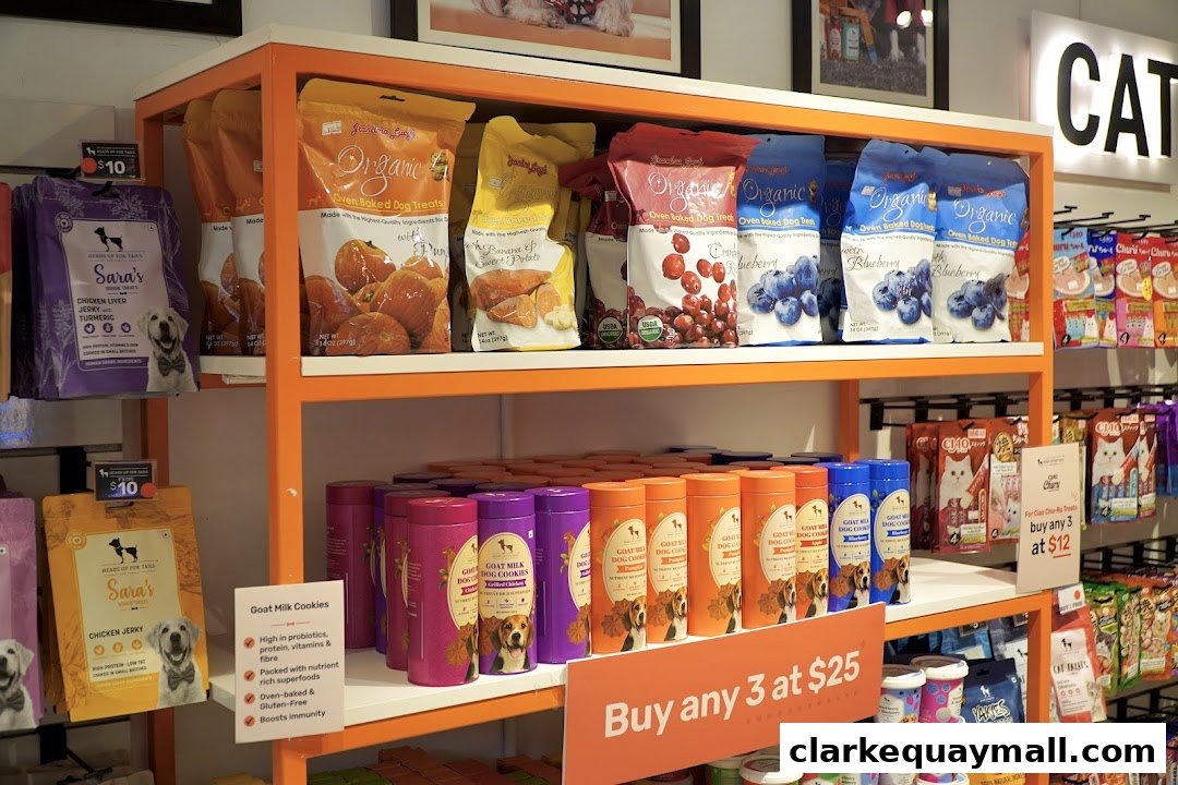 Shelves stocked with various organic dog treats and cat treats, featuring colorful packaging and promotional signs.