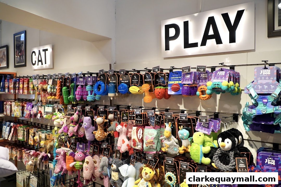 A well-stocked pet store with shelves full of colorful toys for cats and dogs.