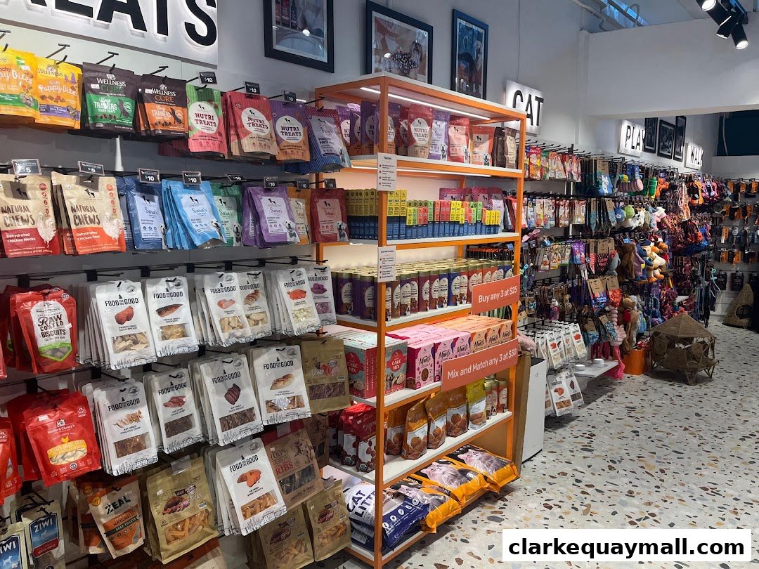 A well-stocked pet store interior featuring shelves filled with various pet food and treat brands.