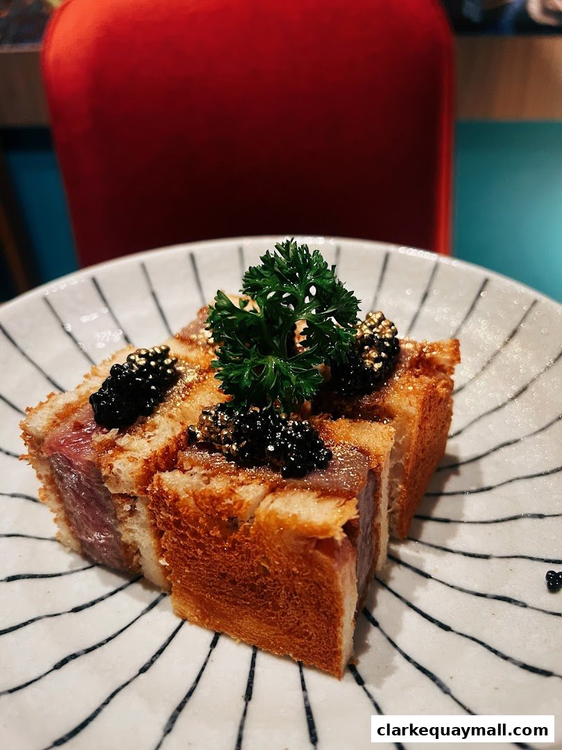 A close-up of a gourmet sandwich with steak, caviar, and parsley on a striped plate.